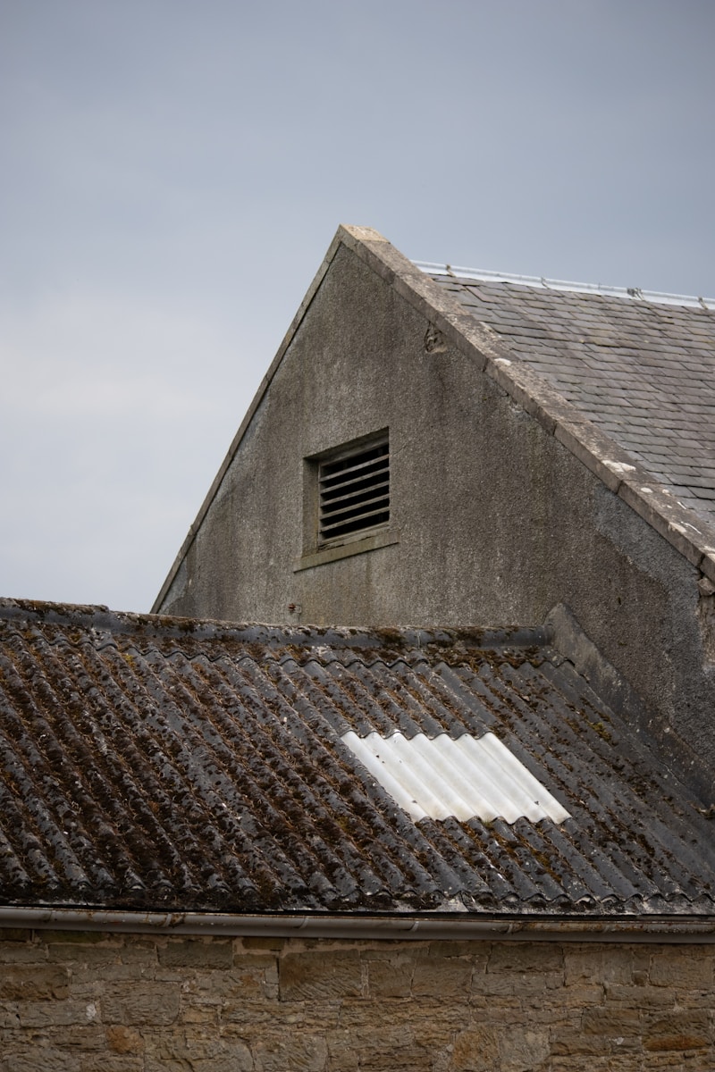 an old building with a small window on the roof