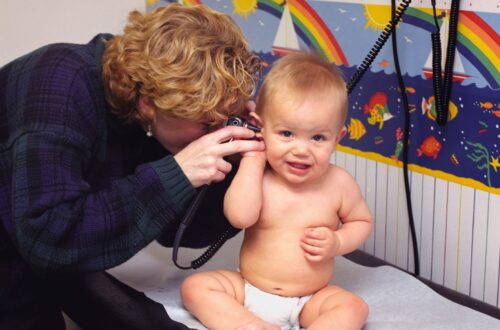 a woman is talking on a phone to a baby